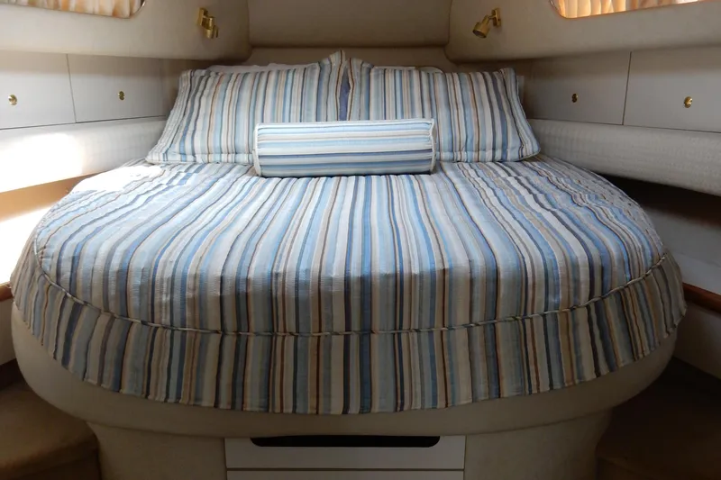 Sandi Yacht Photos Pics 1997 Sea Ray 450 yacht cabin with striped bedding and cozy interior.