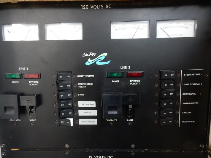 Sandi Yacht Photos Pics Electrical control panel of a 1997 Sea Ray 450 boat, featuring various switches and gauges.