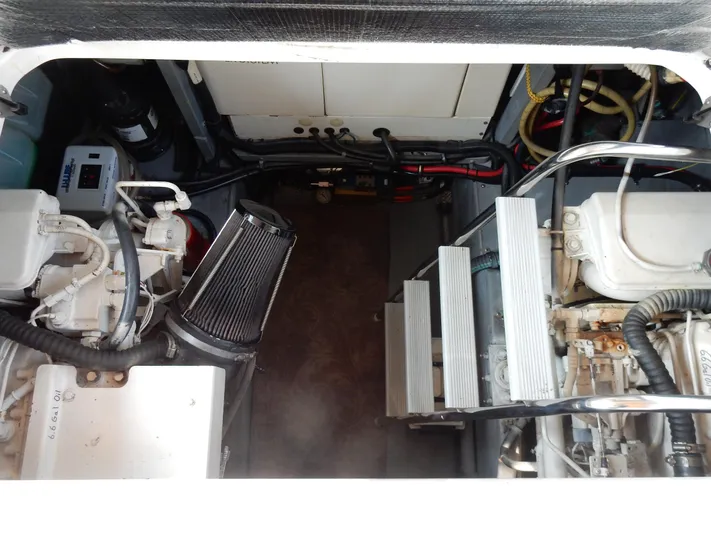 Sandi Yacht Photos Pics Engine compartment of a 1997 Sea Ray 450, showcasing mechanical components and wiring.