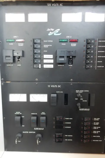 Sandi Yacht Photos Pics Electrical control panel of a 1997 Sea Ray 450 yacht, featuring 120V AC and 12V DC systems.