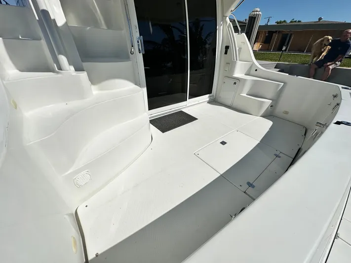 Live Big Yacht Photos Pics 2004 Carver 360 Sport Sedan boat deck with white seating and storage compartments.