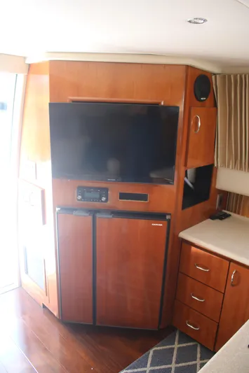 Live Big Yacht Photos Pics 2004 Carver 360 Sport Sedan interior with TV, fridge, and wooden cabinetry.