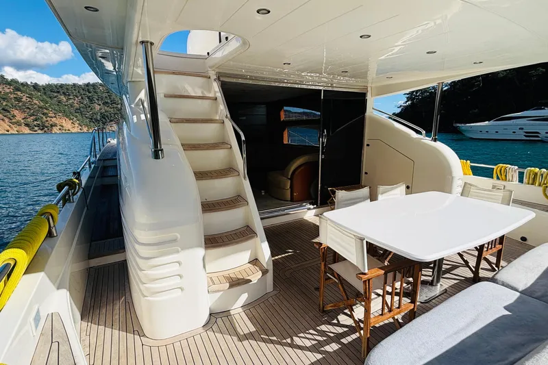  Yacht Photos Pics Luxurious 2007 Princess 21M yacht deck with dining area and scenic ocean view.