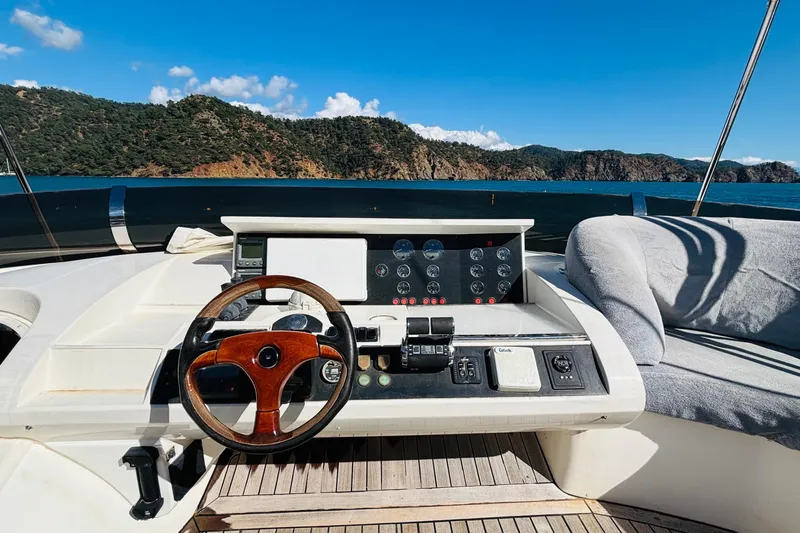  Yacht Photos Pics Steering wheel and dashboard of 2007 Princess 21M yacht with scenic ocean view.