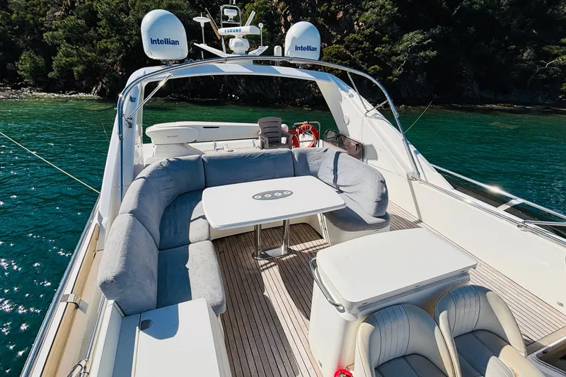  Yacht Photos Pics Luxurious 2007 Princess 21M yacht deck with seating, table, and scenic water view.