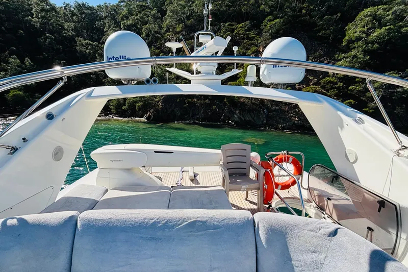  Yacht Photos Pics Luxury Princess 21M yacht deck with seating, overlooking serene green waters, 2007 model.