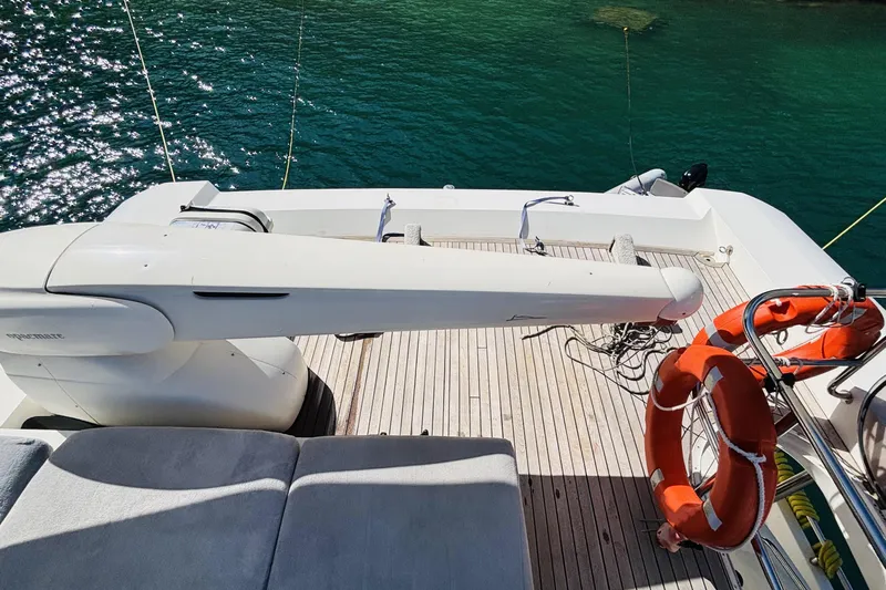  Yacht Photos Pics Deck of 2007 Princess 21M yacht with lifebuoys and crane, overlooking water.