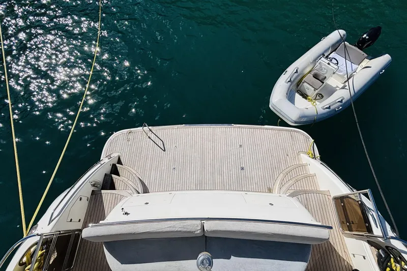  Yacht Photos Pics Aerial view of 2007 Princess 21M yacht deck with tender boat on water.
