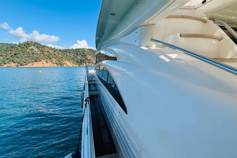  Yacht Photos Pics Side view of a 2007 Princess 21M yacht on calm blue waters.