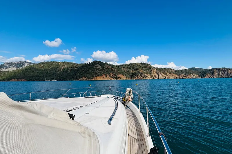  Yacht Photos Pics Luxury yacht Princess 21M cruising near scenic coastline, clear blue sky, 2007 model.