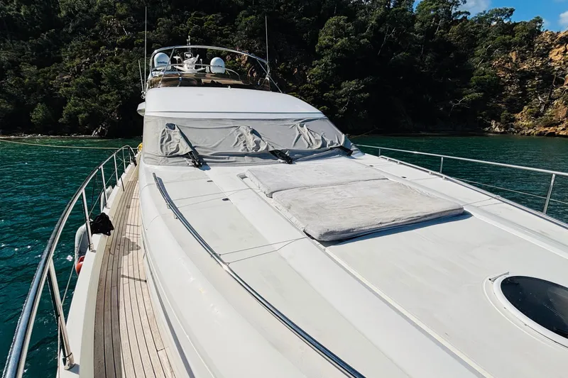  Yacht Photos Pics Luxury Princess 21M yacht from 2007 anchored near lush coastline.