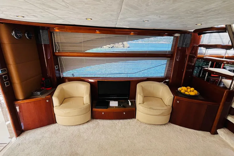  Yacht Photos Pics Luxurious interior of 2007 Princess 21M yacht with leather chairs and scenic window view.