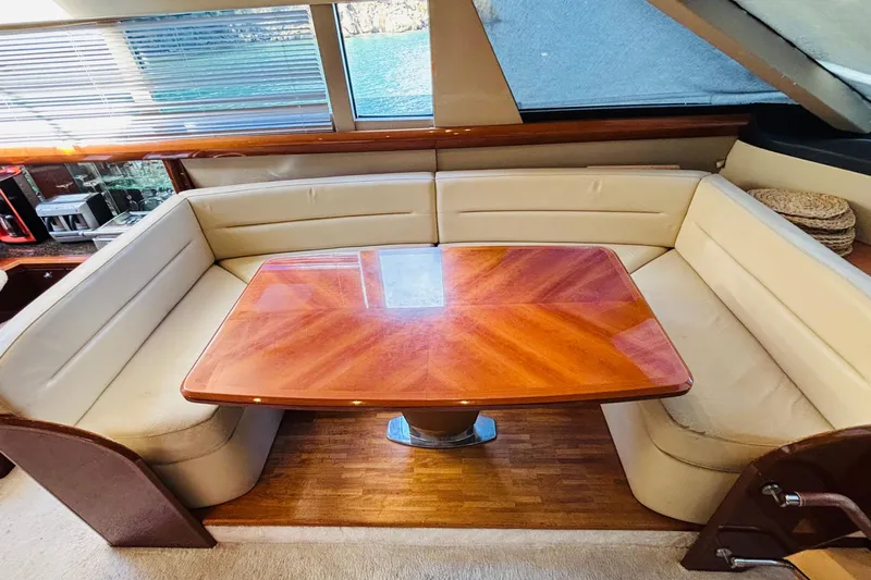  Yacht Photos Pics Luxurious dining area on 2007 Princess 21M yacht with elegant wood table and leather seating.