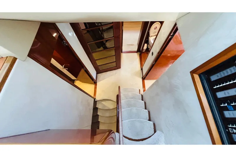  Yacht Photos Pics Interior view of 2007 Princess 21M yacht, featuring elegant stairs and wooden finishes.