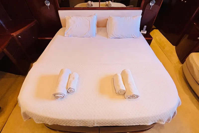 Yacht Photos Pics Luxurious bedroom in 2007 Princess 21M yacht with neatly arranged towels.