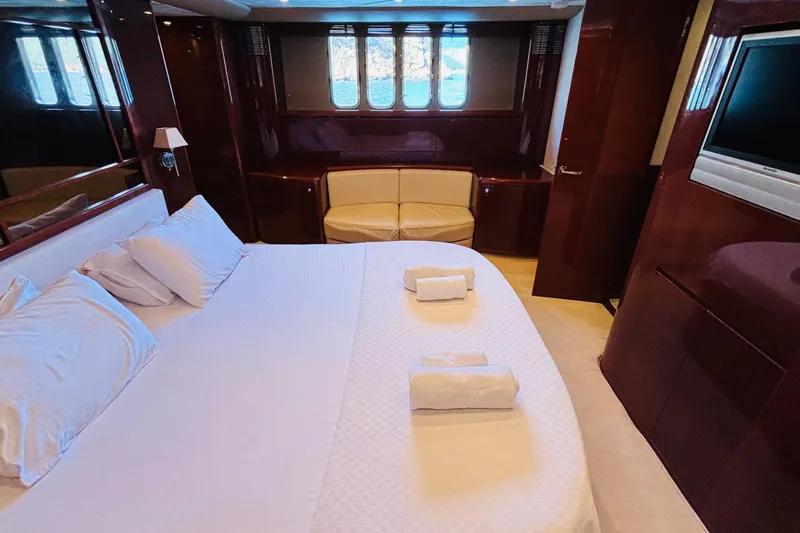  Yacht Photos Pics Luxurious cabin interior of 2007 Princess 21M yacht with bed, seating, and TV.