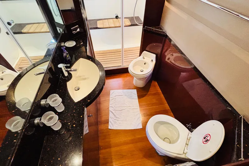  Yacht Photos Pics Luxurious yacht bathroom with modern fixtures, featuring a sink, toilet, and bidet. Princess 21M, 2007.