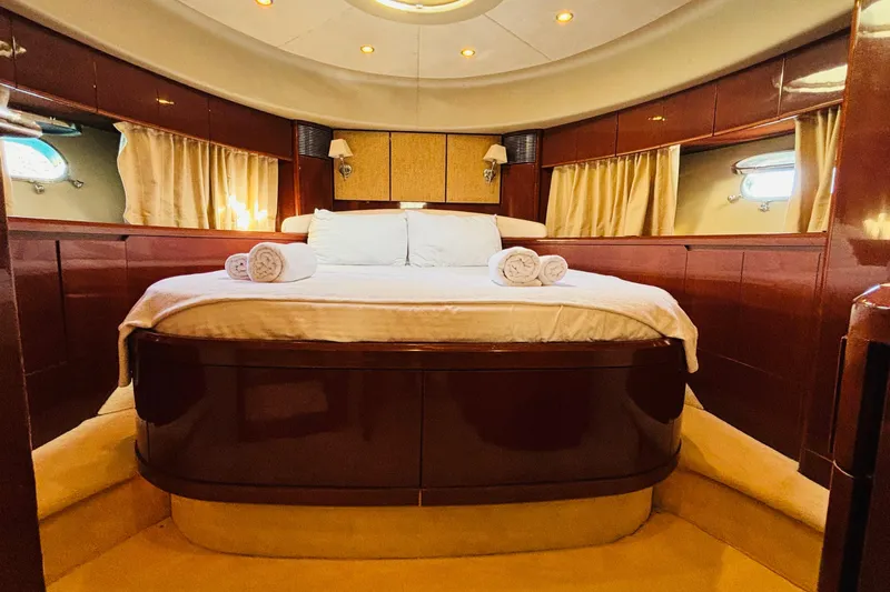  Yacht Photos Pics Luxurious cabin interior of 2007 Princess 21M yacht with elegant bedding and ambient lighting.
