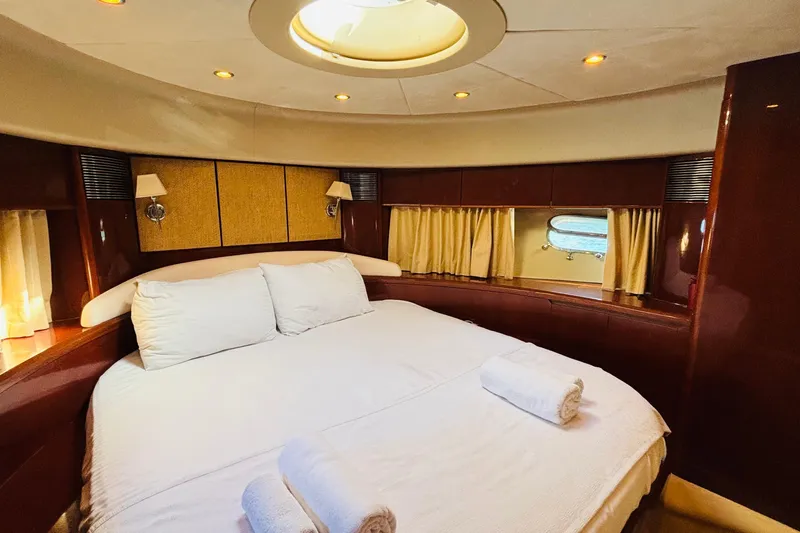  Yacht Photos Pics Luxurious bedroom interior of 2007 Princess 21M yacht with elegant wood finish.