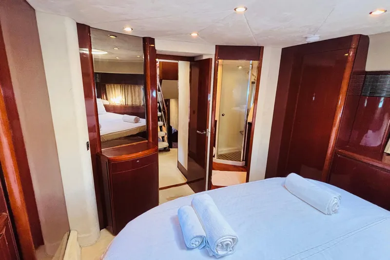  Yacht Photos Pics Luxurious interior of 2007 Princess 21M yacht with elegant wood finishes and cozy bedroom.
