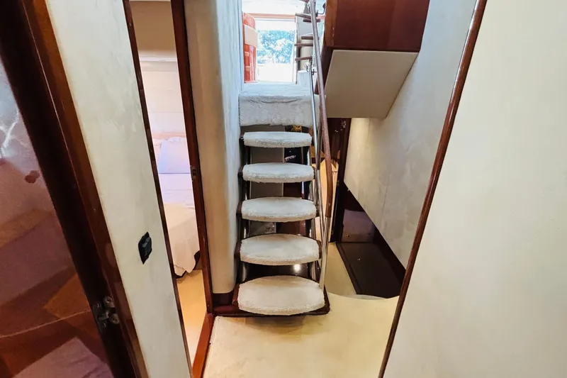  Yacht Photos Pics Interior of 2007 Princess 21M yacht with carpeted stairs and wooden accents.