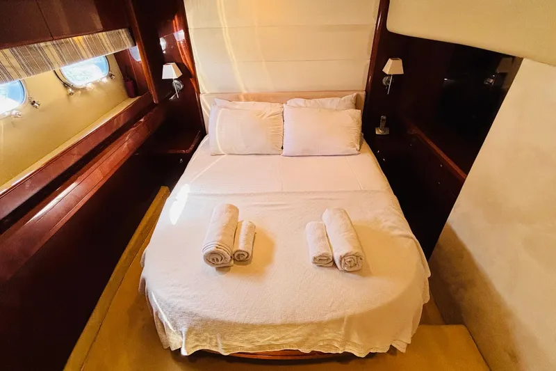  Yacht Photos Pics Luxurious cabin interior of 2007 Princess 21M yacht with neatly arranged bed and towels.