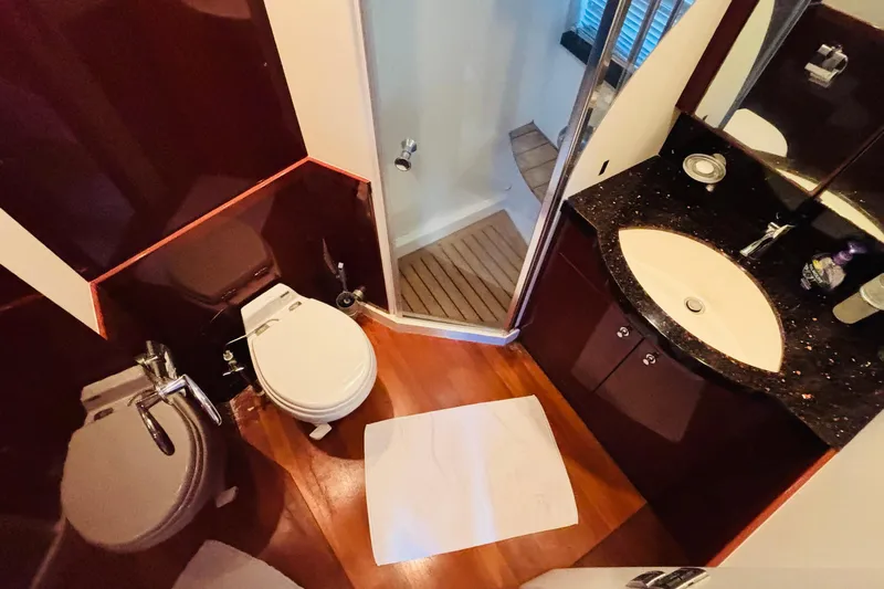  Yacht Photos Pics Luxurious bathroom in 2007 Princess 21M yacht with shower, toilet, and sink.