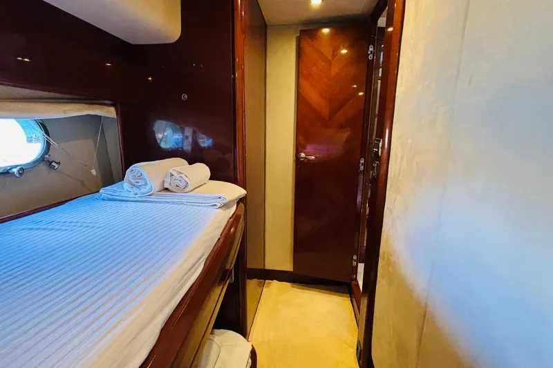  Yacht Photos Pics Luxurious cabin interior of 2007 Princess 21M yacht with bed and porthole.