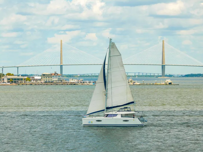 Starry Night Yacht Photos Pics Sailboat Fountaine Pajot Helia 44, 2014, cruising near a suspension bridge on a sunny day.