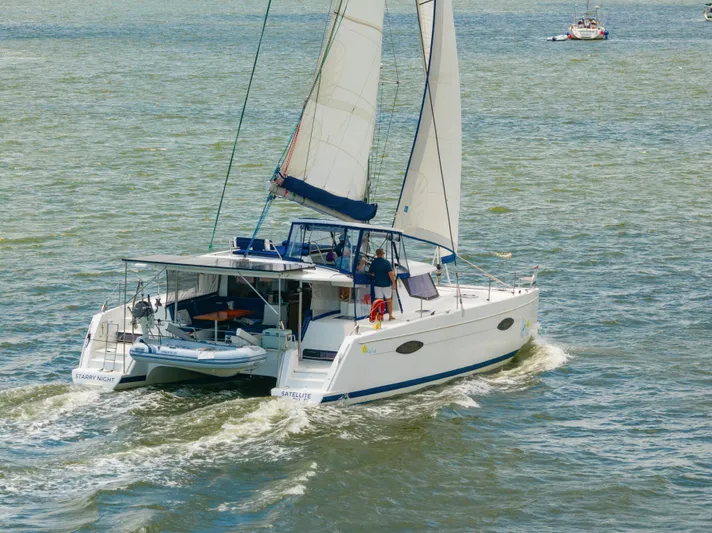 Starry Night Yacht Photos Pics 2014 Fountaine Pajot Helia 44 catamaran sailing on open water.