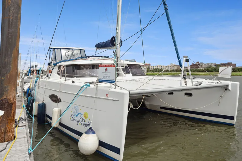 Starry Night Yacht Photos Pics 2014 Fountaine Pajot Helia 44 catamaran docked, featuring sleek design and spacious deck.