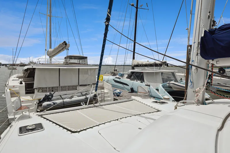 Starry Night Yacht Photos Pics 2014 Fountaine Pajot Helia 44 catamaran docked at marina, clear blue sky.