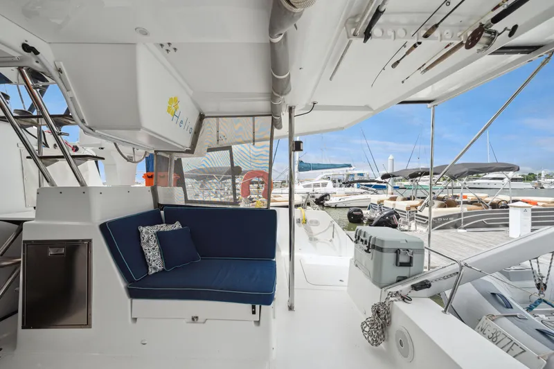 Starry Night Yacht Photos Pics 2014 Fountaine Pajot Helia 44 catamaran interior with blue seating, docked at marina.