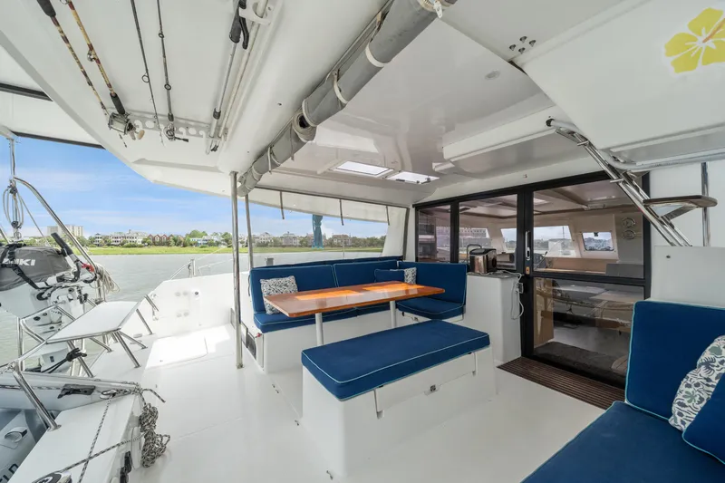 Starry Night Yacht Photos Pics Spacious 2014 Fountaine Pajot Helia 44 catamaran cockpit with blue seating and dining area.