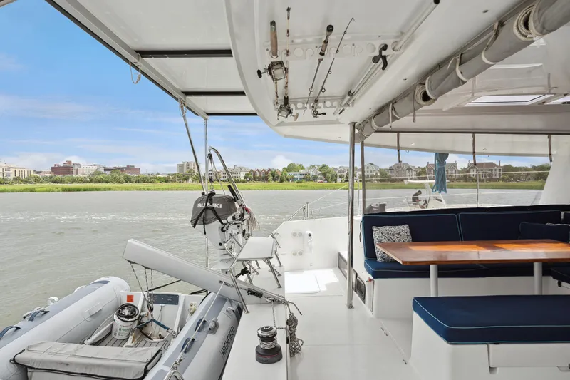Starry Night Yacht Photos Pics 2014 Fountaine Pajot Helia 44 catamaran with outdoor seating and scenic river view.