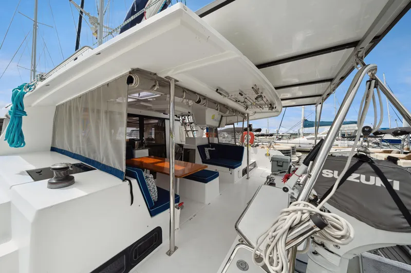 Starry Night Yacht Photos Pics 2014 Fountaine Pajot Helia 44 catamaran with spacious deck and seating area in marina.