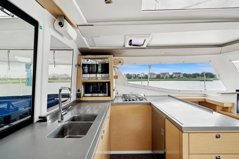 Starry Night Yacht Photos Pics Modern kitchen interior of 2014 Fountaine Pajot Helia 44 catamaran with stainless steel appliances.