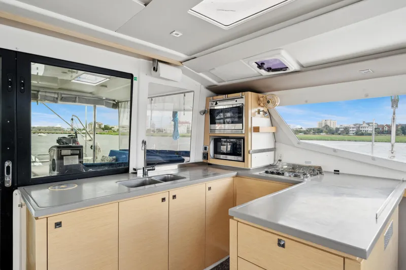 Starry Night Yacht Photos Pics Modern kitchen interior of 2014 Fountaine Pajot Helia 44 catamaran with appliances and scenic window view.