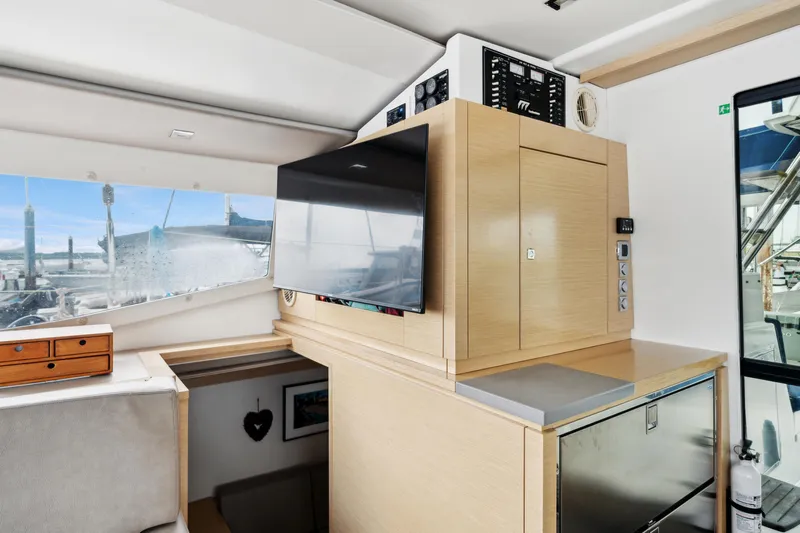 Starry Night Yacht Photos Pics Interior of 2014 Fountaine Pajot Helia 44 catamaran with modern cabinetry and large window view.