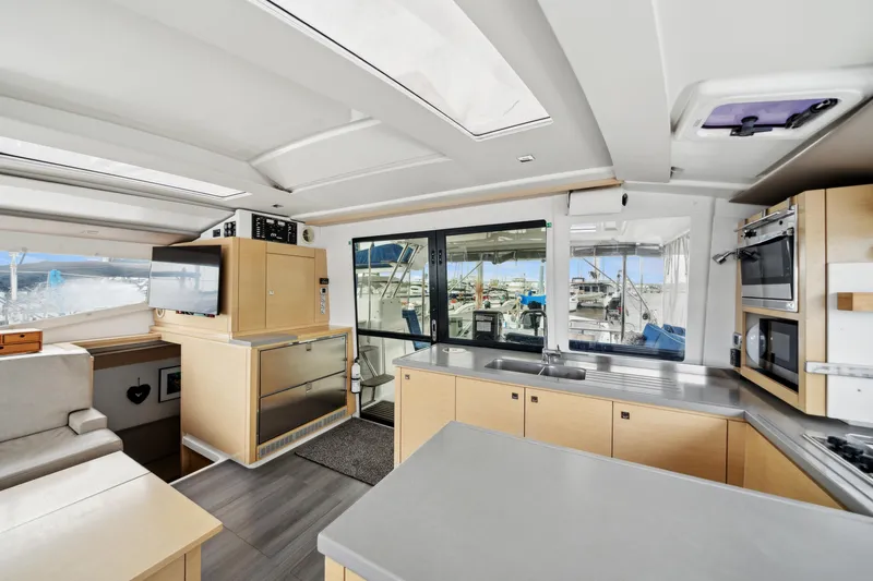 Starry Night Yacht Photos Pics Spacious interior of 2014 Fountaine Pajot Helia 44 catamaran with modern kitchen and seating area.