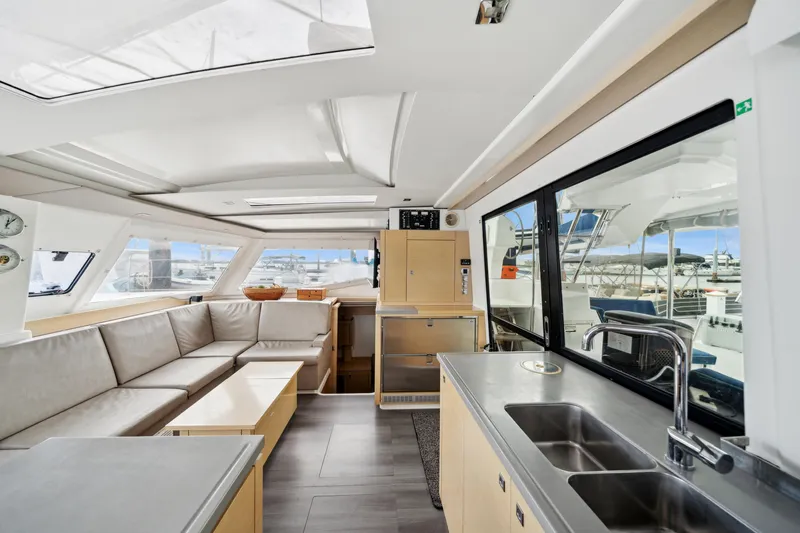 Starry Night Yacht Photos Pics Interior of 2014 Fountaine Pajot Helia 44 catamaran with modern seating and kitchen area.