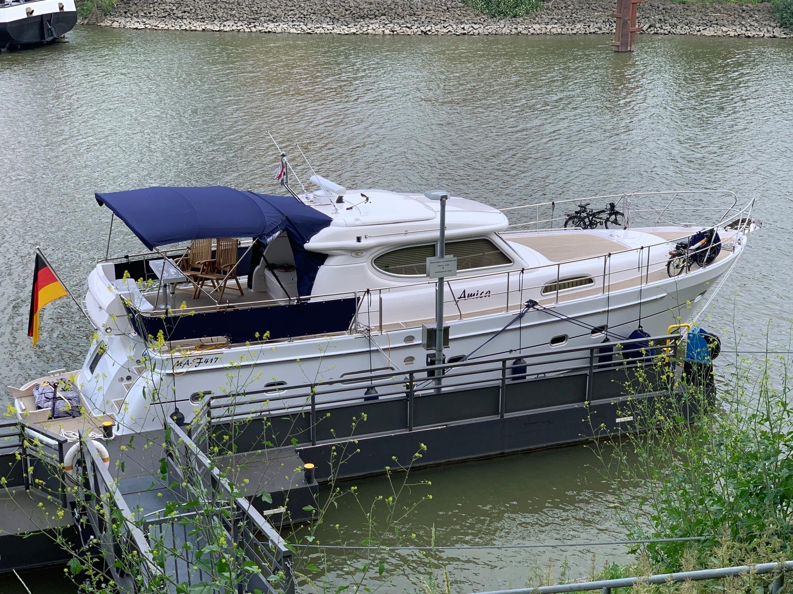 2018 Elling E4 Ultimate yacht docked on a calm river with a German flag.