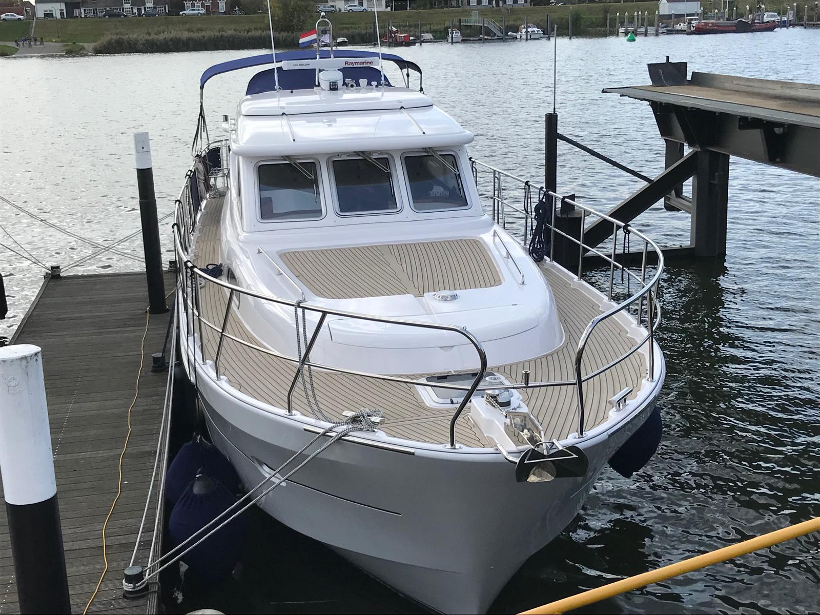 2018 Elling E4 Ultimate yacht docked at a marina, showcasing sleek design and spacious deck.