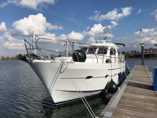 2018 Elling E4 Ultimate yacht docked on a sunny day with blue sky and clouds.