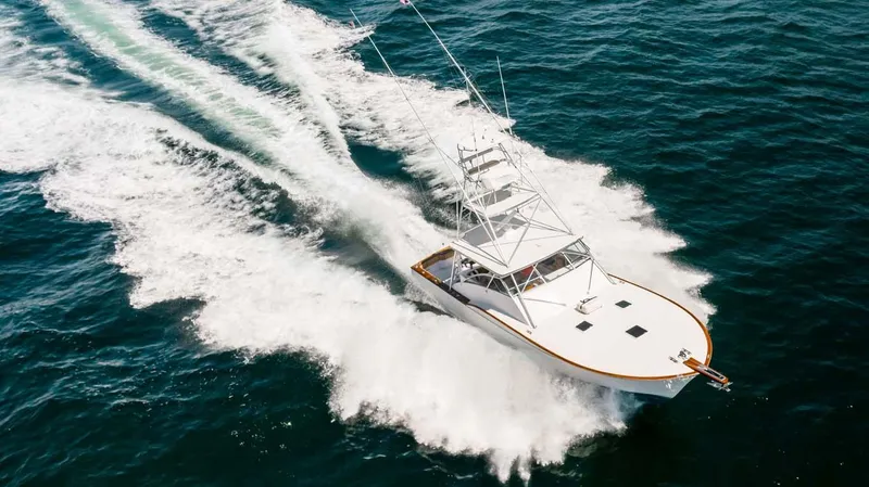  Yacht Photos Pics 1993 Buddy Davis Express Custom Carolina yacht cruising swiftly on open water.