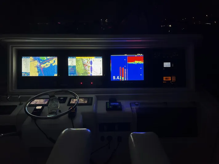 Quite Nice Yacht Photos Pics Dashboard of a 2004 Bertram 570 Convertible yacht with illuminated navigation screens.