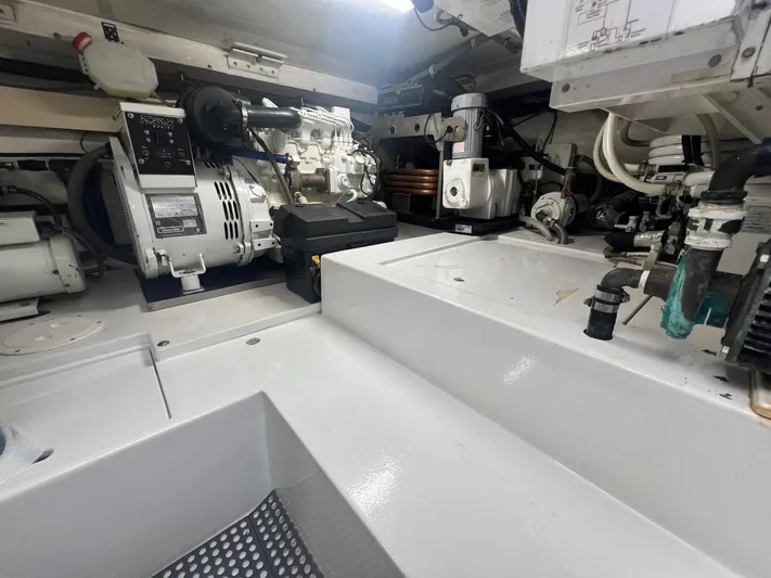 Quite Nice Yacht Photos Pics Engine room of a 2004 Bertram 570 Convertible yacht, showcasing machinery and equipment.