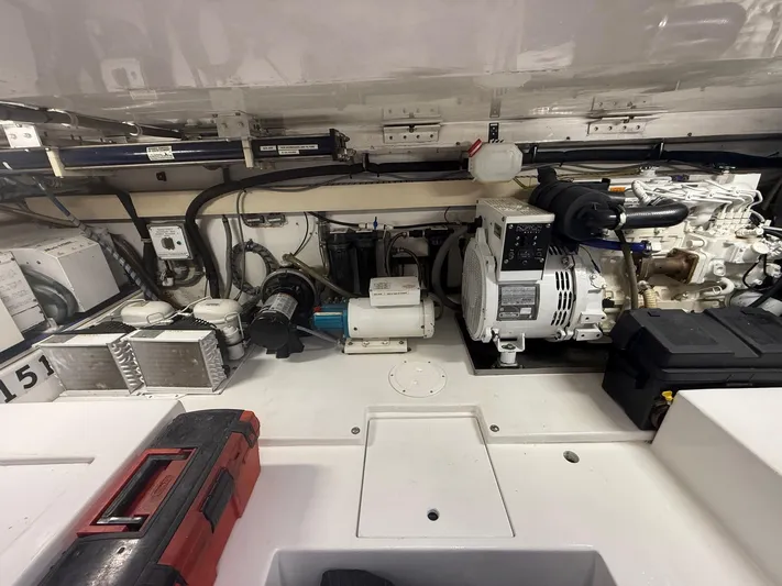 Quite Nice Yacht Photos Pics Engine room of a 2004 Bertram 570 Convertible, showcasing mechanical components and tools.