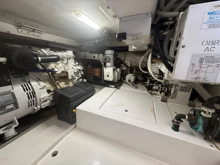 Quite Nice Yacht Photos Pics Engine room of a 2004 Bertram 570 Convertible yacht, showcasing machinery and equipment.