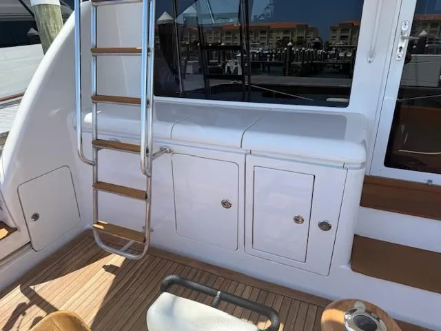 Quite Nice Yacht Photos Pics 2004 Bertram 570 Convertible yacht deck with ladder and storage compartments.
